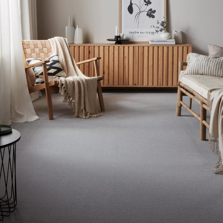 A natural inspired seating area with wooden chairs & accessories & light grey carpet