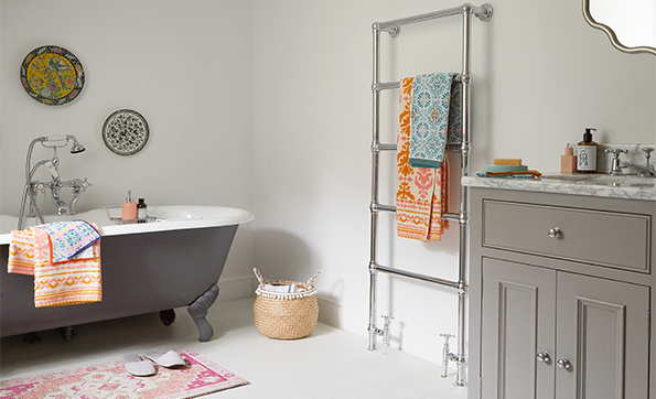 Bathroom with grey bath and coloured towels
