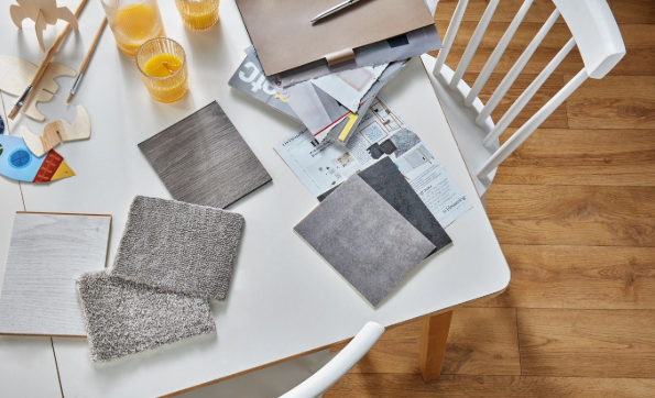 A white table with flooring samples on