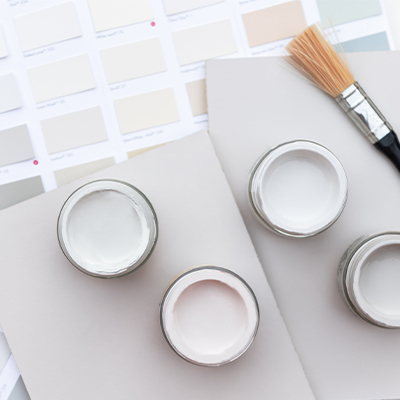 Overhead of open paint pots and paint swatches